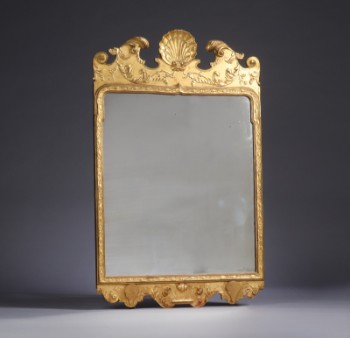 Mirror in rococo form in a frame of gilded wood, first half of the 20th century
