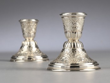 A pair of low Egyptian silver candlesticks (2)