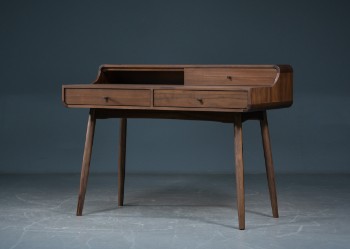 Desk in walnut with three drawers.