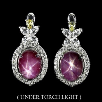 Earrings in rhodium-plated Sterling silver adorned with rubies and topazes.
