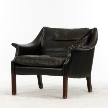 Patinated leather armchair